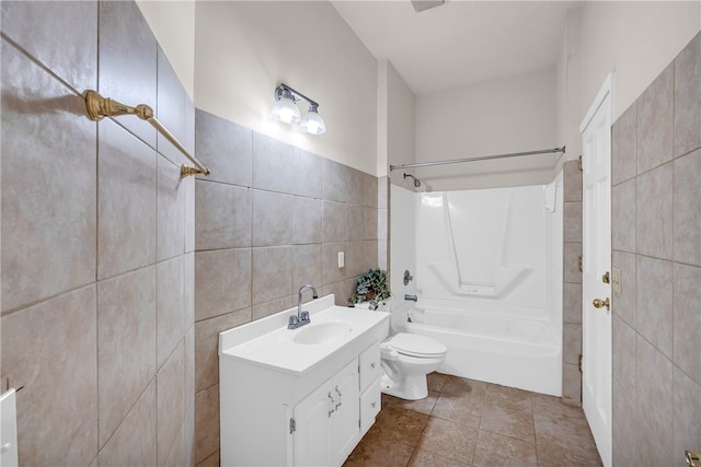 full bathroom with shower / bathing tub combination, tile walls, vanity, and toilet