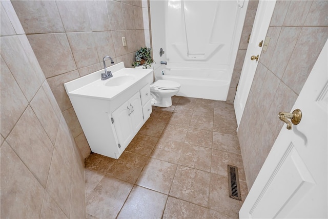 full bathroom featuring tile walls, vanity, toilet, bathtub / shower combination, and tile patterned floors