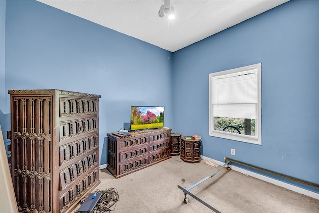 interior space featuring a textured ceiling, carpet floors, and ceiling fan