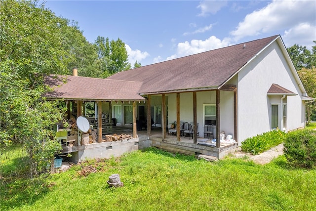 rear view of property with a lawn