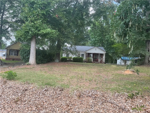 view of front of home featuring a storage unit