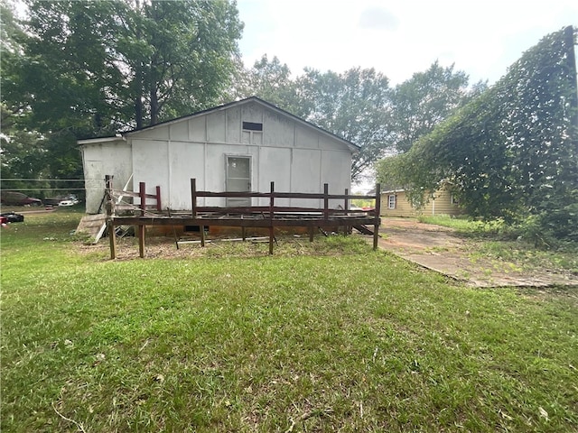 rear view of property with a deck and a yard