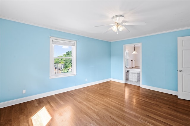 unfurnished bedroom with wood-type flooring, crown molding, ensuite bath, and ceiling fan