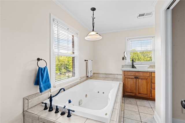 bathroom with crown molding, a healthy amount of sunlight, tiled tub, and vanity