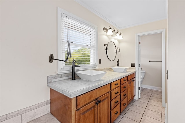 bathroom featuring ornamental molding, vanity, toilet, and tile patterned floors