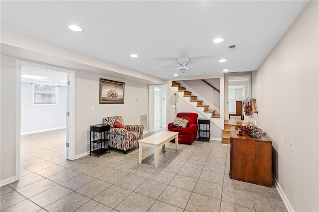 tiled living room with ceiling fan