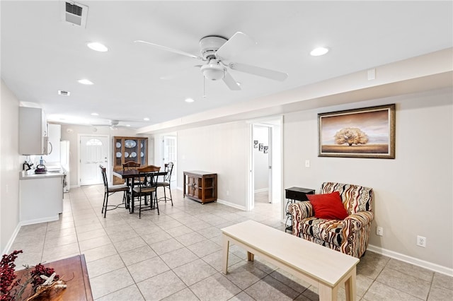 living room featuring light tile patterned flooring and ceiling fan