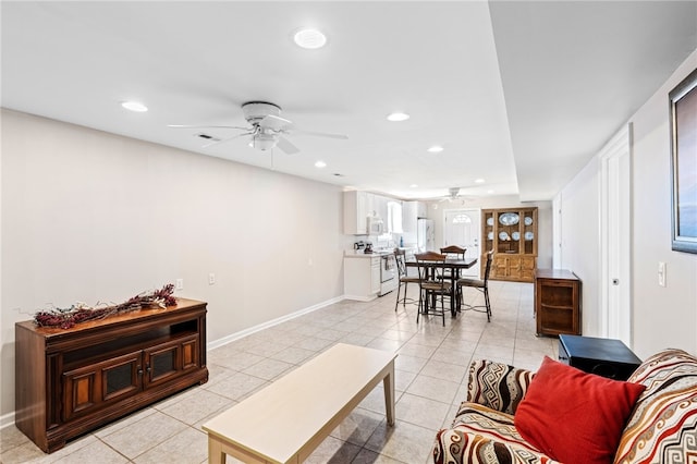 tiled living room featuring ceiling fan and plenty of natural light