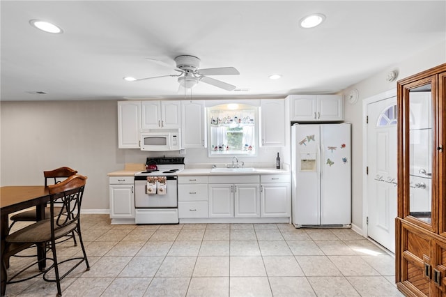 kitchen with white cabinetry, white appliances, light tile patterned floors, ceiling fan, and sink