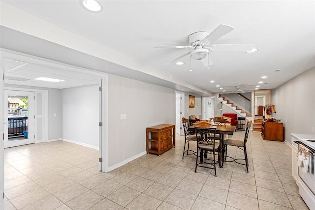 dining space with light tile patterned flooring and ceiling fan