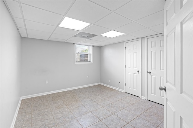 basement with a paneled ceiling