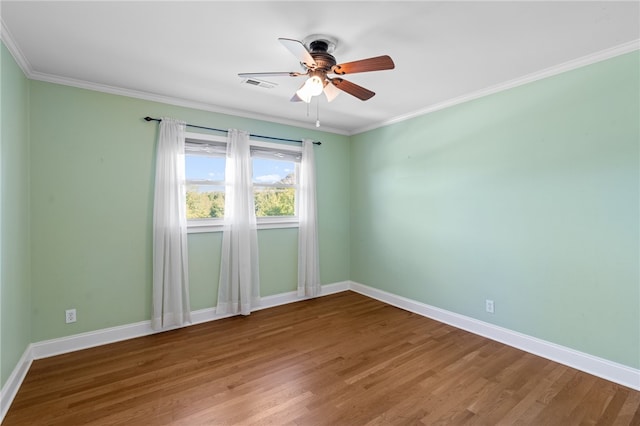 spare room with ceiling fan, crown molding, and hardwood / wood-style floors