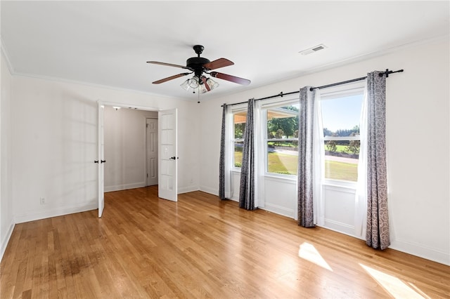 unfurnished bedroom with ornamental molding, light hardwood / wood-style floors, and ceiling fan