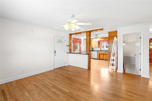 unfurnished living room featuring ceiling fan, ornamental molding, and light hardwood / wood-style floors