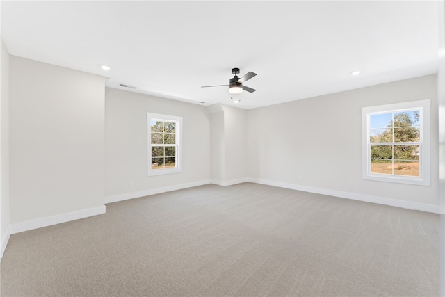 carpeted spare room featuring ceiling fan