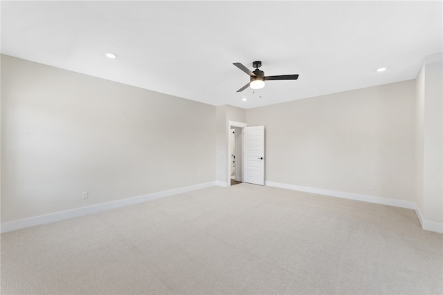 carpeted spare room with ceiling fan