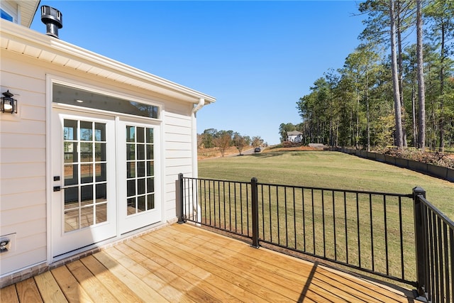 wooden terrace featuring french doors and a lawn