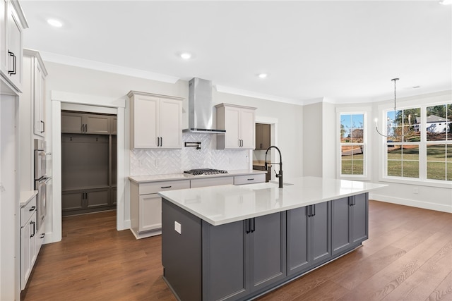 kitchen featuring wall chimney exhaust hood, sink, and gray cabinets