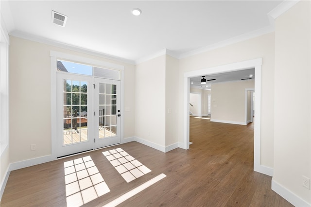 spare room with crown molding, ceiling fan, and dark hardwood / wood-style flooring