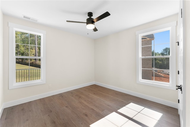 spare room with hardwood / wood-style flooring and ceiling fan