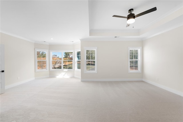 unfurnished living room with crown molding, light carpet, and ceiling fan