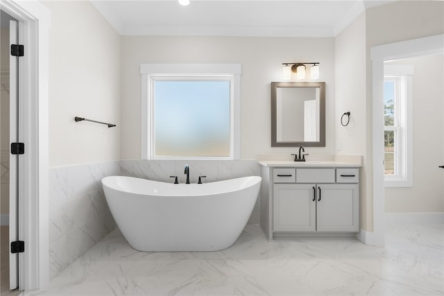 bathroom featuring vanity, a bathtub, tile walls, and ornamental molding