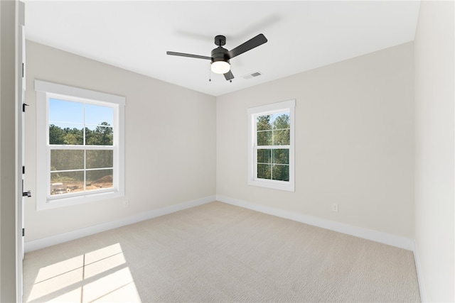 carpeted spare room with ceiling fan