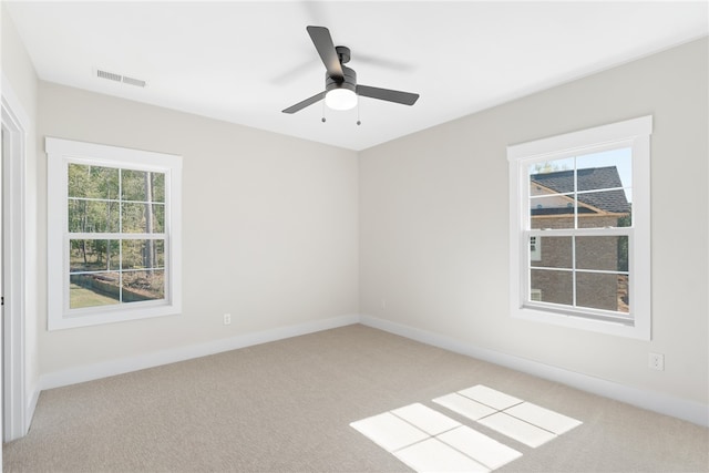 spare room with light carpet and ceiling fan