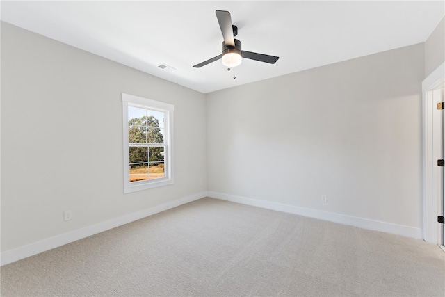 unfurnished room with ceiling fan and carpet floors