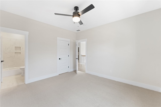 unfurnished bedroom with connected bathroom, ceiling fan, and light colored carpet