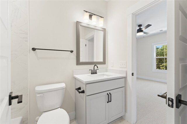 bathroom featuring vanity, toilet, and ceiling fan