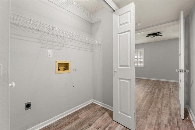 laundry room featuring washer hookup, laundry area, electric dryer hookup, wood finished floors, and baseboards