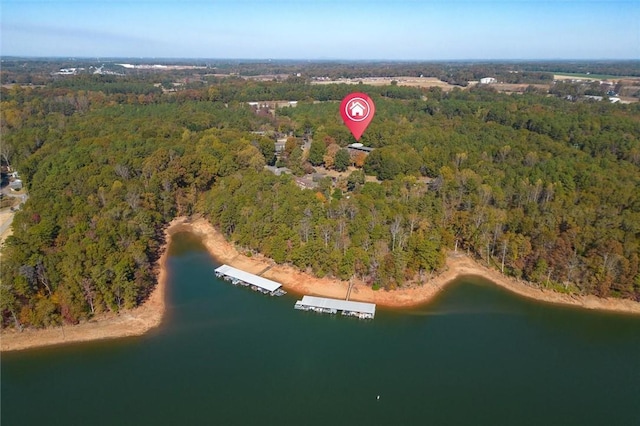 drone / aerial view featuring a water view and a wooded view