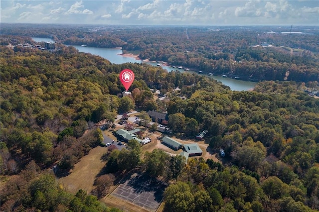 drone / aerial view with a water view and a wooded view