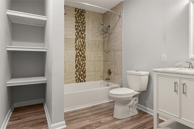 full bath featuring vanity, shower / bathing tub combination, toilet, and wood finished floors