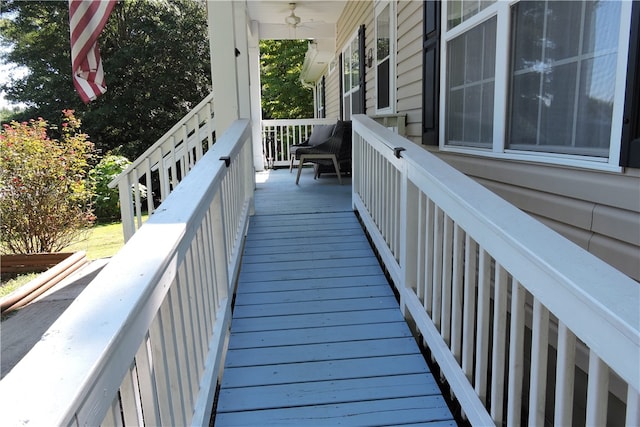 wooden deck with covered porch and ceiling fan