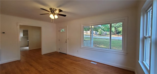 unfurnished room with ceiling fan and hardwood / wood-style flooring