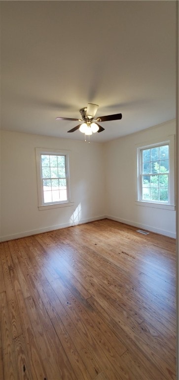 spare room with ceiling fan and light hardwood / wood-style floors