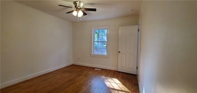 spare room featuring ceiling fan and dark hardwood / wood-style floors