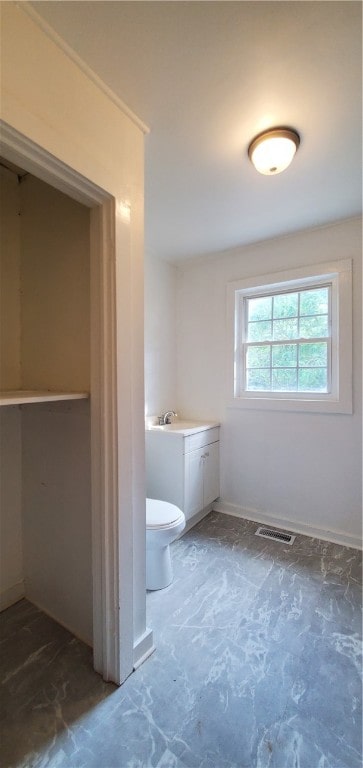 bathroom featuring vanity and toilet