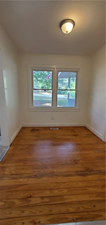 spare room with hardwood / wood-style floors