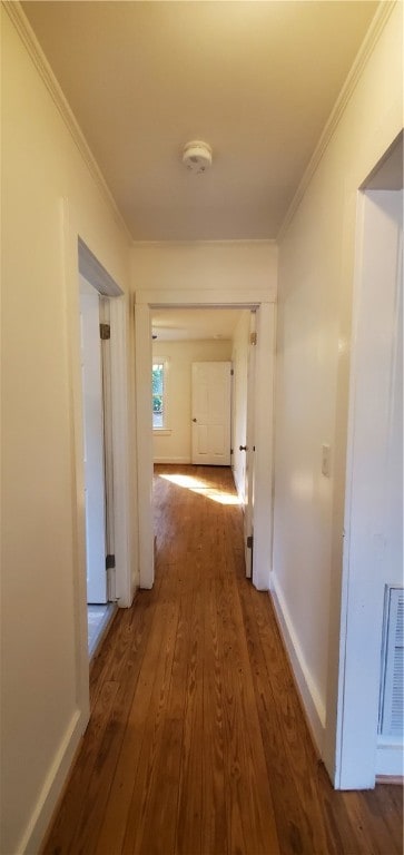 hall with ornamental molding and dark hardwood / wood-style flooring