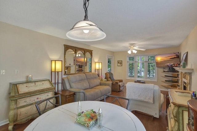 living room with dark hardwood / wood-style flooring and ceiling fan