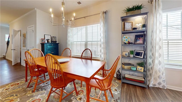 dining room with dark wood-type flooring, a chandelier, and a healthy amount of sunlight