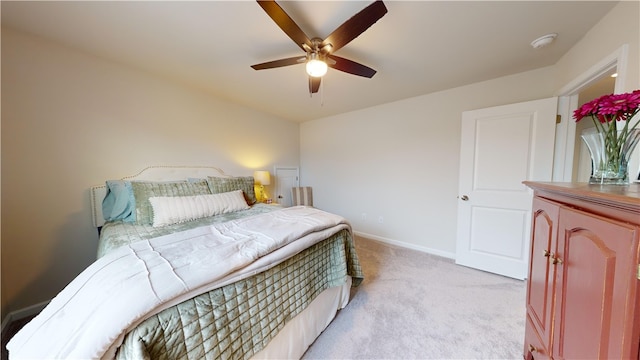 bedroom featuring light carpet and ceiling fan