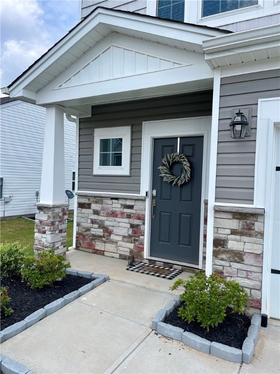 view of exterior entry with a porch