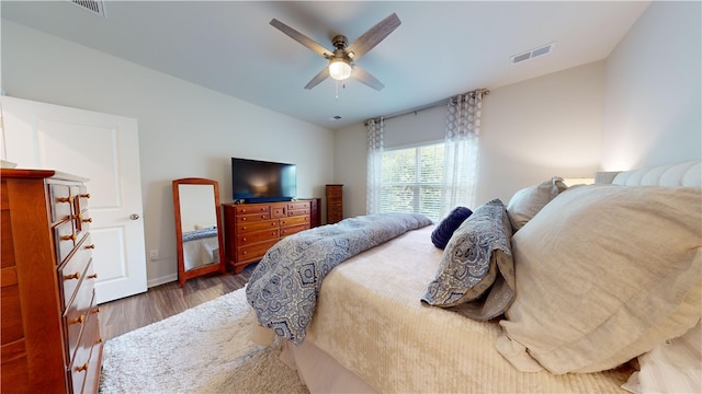 bedroom featuring ceiling fan and dark wood-type flooring