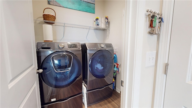 laundry area featuring washer and clothes dryer and hardwood / wood-style floors