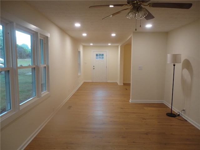 interior space with ceiling fan and light hardwood / wood-style floors