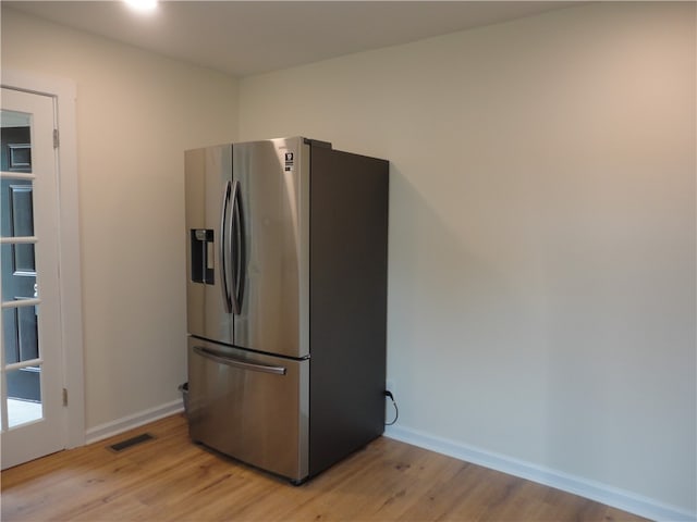 kitchen featuring light hardwood / wood-style flooring and stainless steel fridge